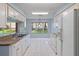 Bright kitchen featuring white appliances and a garden view at 2165 Springmeadow Dr, Spring Hill, FL 34606