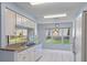 Updated kitchen features granite countertops and white appliances, with a garden view at 2165 Springmeadow Dr, Spring Hill, FL 34606