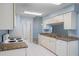 Well-equipped kitchen with white tile floors, granite countertops and an easy flow layout at 2165 Springmeadow Dr, Spring Hill, FL 34606