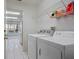 Bright laundry room featuring a washer, dryer, and storage at 2165 Springmeadow Dr, Spring Hill, FL 34606