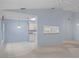 Open-concept living and dining area with a view of the kitchen and multiple lighting options at 2165 Springmeadow Dr, Spring Hill, FL 34606