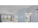 Bright living room area open to the kitchen, with vaulted ceilings and plenty of natural light at 2165 Springmeadow Dr, Spring Hill, FL 34606