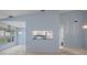 Open-concept living and dining area with a view of the kitchen and sliding glass doors to the outdoors at 2165 Springmeadow Dr, Spring Hill, FL 34606