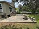 The backyard with a concrete patio and a cement table, ideal for outdoor relaxation at 221 Highland St, Brooksville, FL 34601