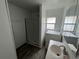The bathroom has new vinyl floors, a walk-in shower, vanity sink, and an updated mirror at 221 Highland St, Brooksville, FL 34601