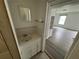 Bathroom features a single sink vanity with storage and a mirror at 221 Highland St, Brooksville, FL 34601