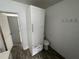 Bathroom features built-in storage, a toilet, and access to another room at 221 Highland St, Brooksville, FL 34601