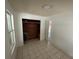 A bright bedroom featuring tiled floors, a closet, and a window offering natural light at 221 Highland St, Brooksville, FL 34601