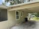 View of the covered carport with details of the home's construction and the surrounding area at 221 Highland St, Brooksville, FL 34601