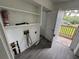 Laundry room boasts extra storage shelves and an exterior door to the deck at 221 Highland St, Brooksville, FL 34601