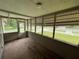 Enclosed front porch featuring brick flooring and screened openings for natural light and air at 221 Highland St, Brooksville, FL 34601