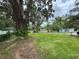 A spacious yard shaded by mature trees at 221 Highland St, Brooksville, FL 34601