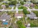 An aerial view of the property, showcasing its layout and surrounding neighborhood with mature trees at 2450 Ambassador Ave, Spring Hill, FL 34609