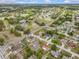 A serene neighborhood is captured in an aerial view, showcasing the property's location and landscaping at 2450 Ambassador Ave, Spring Hill, FL 34609