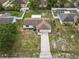 Aerial view showcasing the single-story home, spacious yard, and well-kept neighborhood at 2450 Ambassador Ave, Spring Hill, FL 34609