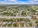 A captivating aerial view of the home nestled in a well-established neighborhood surrounded by lush landscapes at 2450 Ambassador Ave, Spring Hill, FL 34609