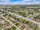 An aerial view reveals the home's setting within a community with a mix of residential properties and streets at 2450 Ambassador Ave, Spring Hill, FL 34609