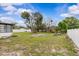 The expansive backyard is surrounded by a white fence, providing privacy and security at 2450 Ambassador Ave, Spring Hill, FL 34609
