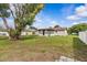 Backyard view of the house exterior showing the sunroom and mature trees in a green space at 2450 Ambassador Ave, Spring Hill, FL 34609