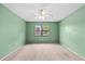 Spacious bedroom featuring a ceiling fan, neutral carpet and a bright window at 2450 Ambassador Ave, Spring Hill, FL 34609