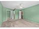 Bedroom with closet, ceiling fan, and access to kitchen and bathroom at 2450 Ambassador Ave, Spring Hill, FL 34609