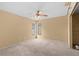 Spacious bedroom featuring neutral walls, carpet, and a ceiling fan with lighting at 2450 Ambassador Ave, Spring Hill, FL 34609