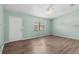 Bright living room showcasing modern wood flooring and a ceiling fan at 2450 Ambassador Ave, Spring Hill, FL 34609
