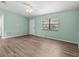 Cozy living room featuring wood flooring and a ceiling fan at 2450 Ambassador Ave, Spring Hill, FL 34609