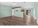 Bright open-concept living room featuring stylish wood flooring and open floor plan at 2450 Ambassador Ave, Spring Hill, FL 34609