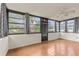 Sunroom featuring tile floors, exterior access door, and many windows with views at 2450 Ambassador Ave, Spring Hill, FL 34609