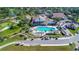 Aerial view of a pool surrounded by a golf course at 2481 Whispering Pines Ct, Spring Hill, FL 34606