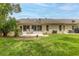 A view of the back of the house and a lush green lawn at 2481 Whispering Pines Ct, Spring Hill, FL 34606