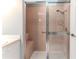 Bathroom shower features a glass door with a silver frame and a built-in bench at 2481 Whispering Pines Ct, Spring Hill, FL 34606