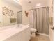 Bathroom features a white sink and a tiled shower with decorative accents at 2481 Whispering Pines Ct, Spring Hill, FL 34606