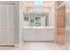 Bathroom with dual sinks, a large mirror, a walk-in shower, and a closet at 2481 Whispering Pines Ct, Spring Hill, FL 34606