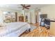 Bedroom featuring a hardwood floor, an office desk, and a view to the dining room at 2481 Whispering Pines Ct, Spring Hill, FL 34606