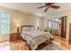 Comfortable bedroom with hardwood floors, a ceiling fan, and a sliding glass door at 2481 Whispering Pines Ct, Spring Hill, FL 34606
