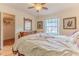 Bedroom features wood flooring, a walk-in closet, and neutral decor at 2481 Whispering Pines Ct, Spring Hill, FL 34606