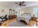 Comfortable bedroom with hardwood floors, a ceiling fan, and neutral paint at 2481 Whispering Pines Ct, Spring Hill, FL 34606