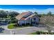 Exterior view of the community clubhouse featuring a well-maintained lawn and architectural details at 2481 Whispering Pines Ct, Spring Hill, FL 34606
