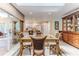 Dining area with glass table, seating, and display cabinet at 2481 Whispering Pines Ct, Spring Hill, FL 34606