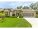 Charming home with a well-manicured lawn and attractive landscaping at 2481 Whispering Pines Ct, Spring Hill, FL 34606