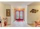 Inviting foyer featuring tile flooring and an ornate red double door at 2481 Whispering Pines Ct, Spring Hill, FL 34606