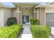 Welcoming home entrance featuring a well-maintained walkway surrounded by lush greenery at 2481 Whispering Pines Ct, Spring Hill, FL 34606