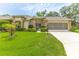Charming single-story home with a well-manicured lawn and a screened garage in a serene neighborhood at 2481 Whispering Pines Ct, Spring Hill, FL 34606