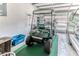 A clean garage featuring a golf cart and vehicle at 2481 Whispering Pines Ct, Spring Hill, FL 34606