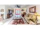 Cozy living room with neutral walls, comfortable seating, ceiling fan, and lots of natural light at 2481 Whispering Pines Ct, Spring Hill, FL 34606