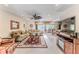 Cozy living room with neutral walls, comfortable seating, ceiling fan, and lots of natural light at 2481 Whispering Pines Ct, Spring Hill, FL 34606