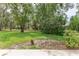 Beautiful green space of the yard with mature trees at 2481 Whispering Pines Ct, Spring Hill, FL 34606