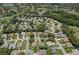 Expansive aerial photo showcases a neighborhood, green spaces, and winding streets at 2486 Deer Trail Ln, Spring Hill, FL 34606